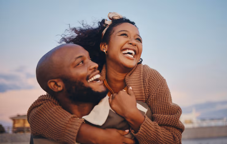 A happy couple embracing outdoors